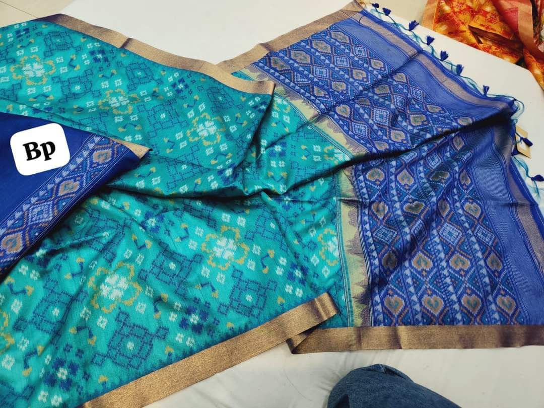 blue saree with a brand logo in the corner.