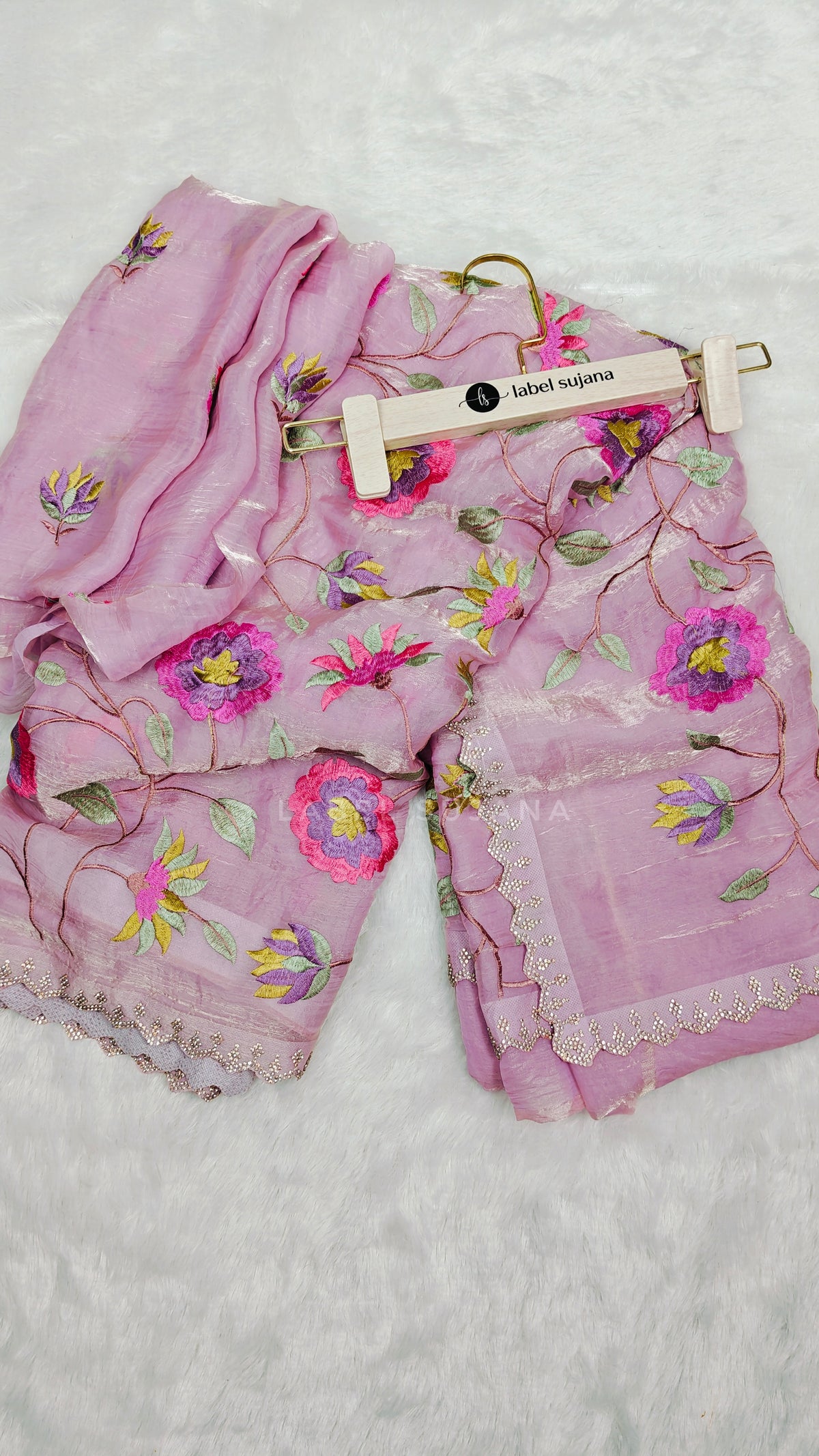 baby pink saree with colorful floral embroidery and a matching embroidered blouse