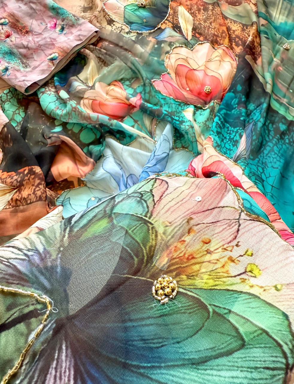 Baby pink colorful fabric with floral patterns and a brooch.