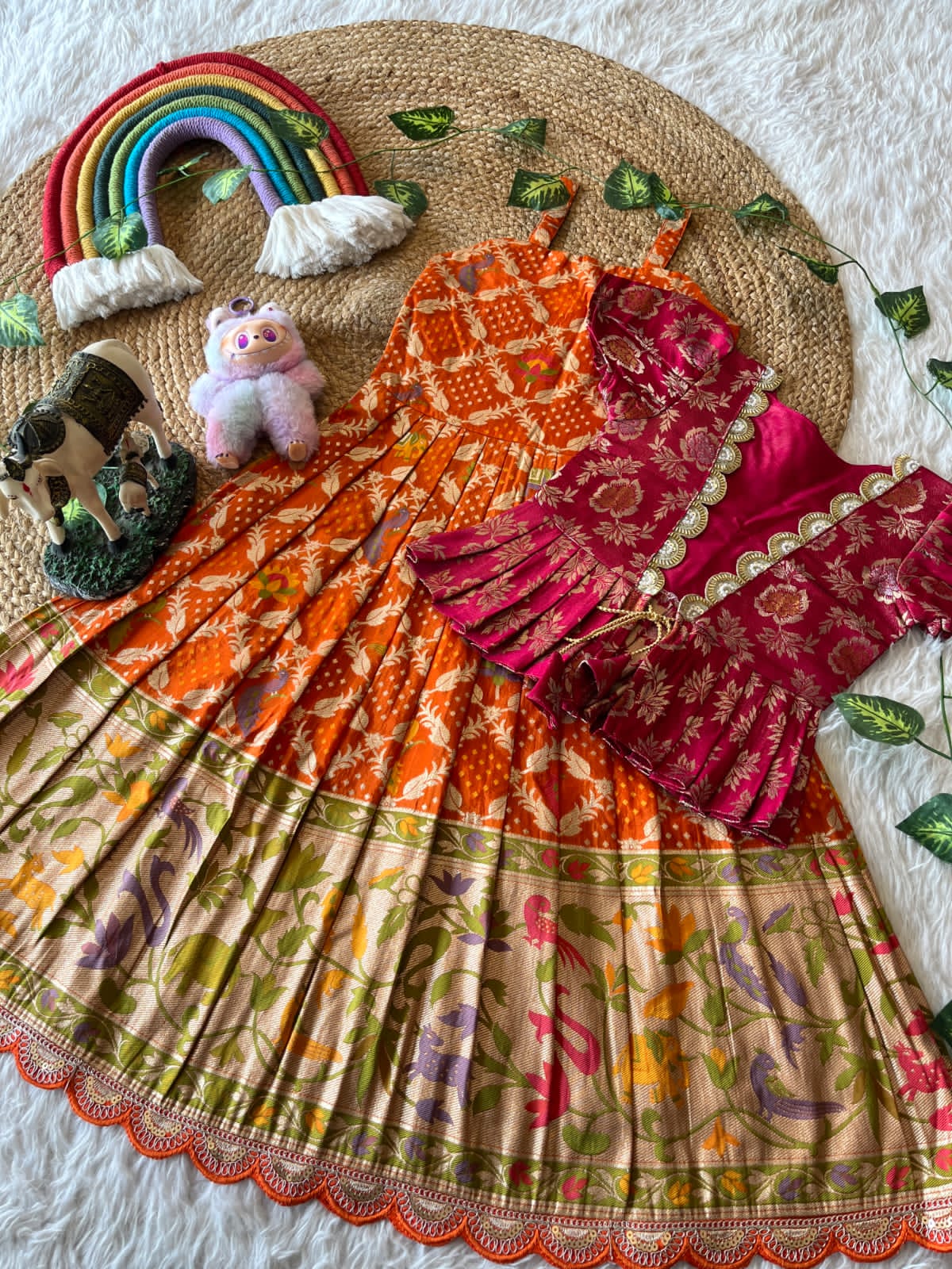 Colorful orange traditional saree with a blouse on a texture surface