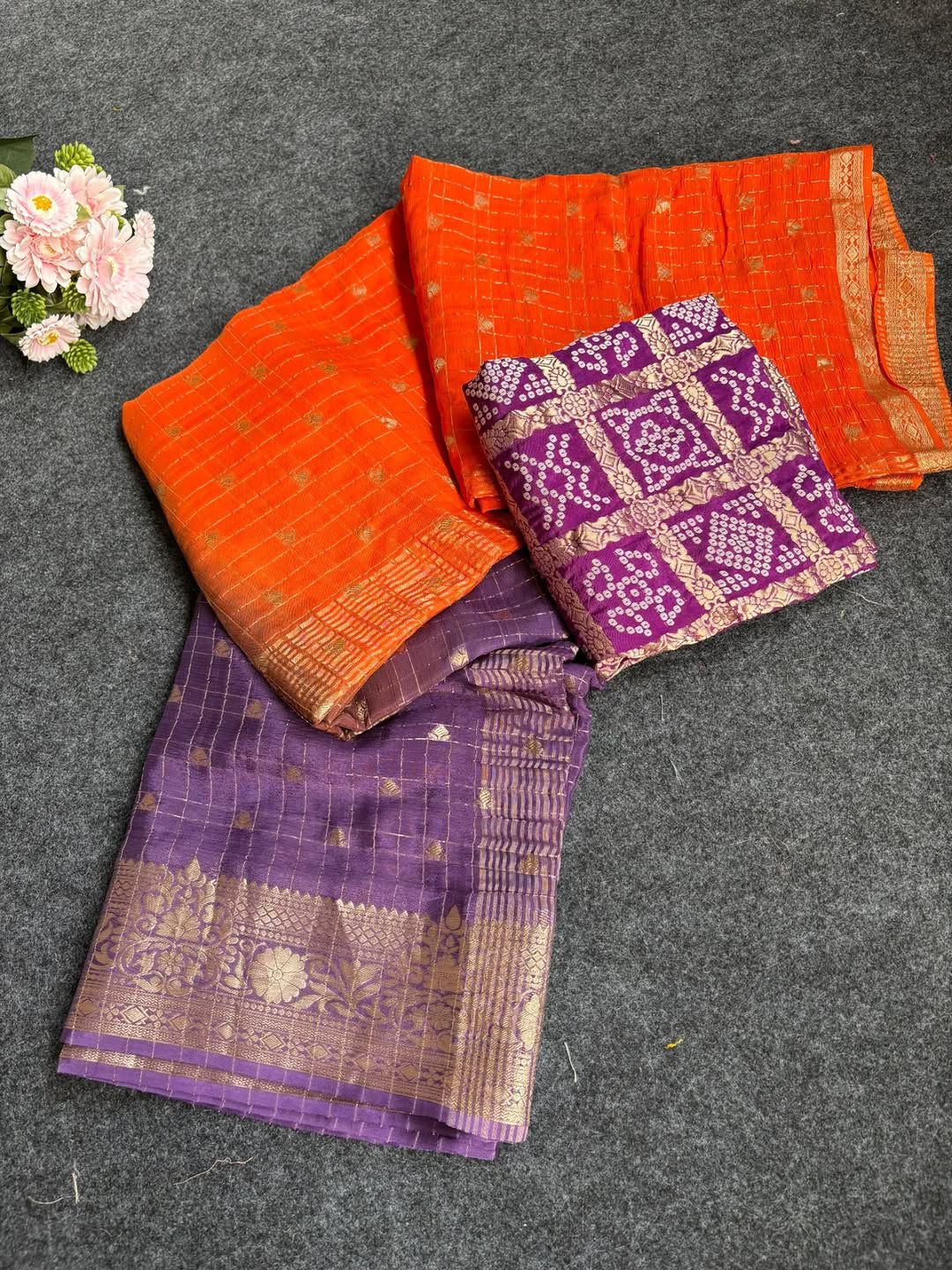 Purple sarees with floral decorations on a background