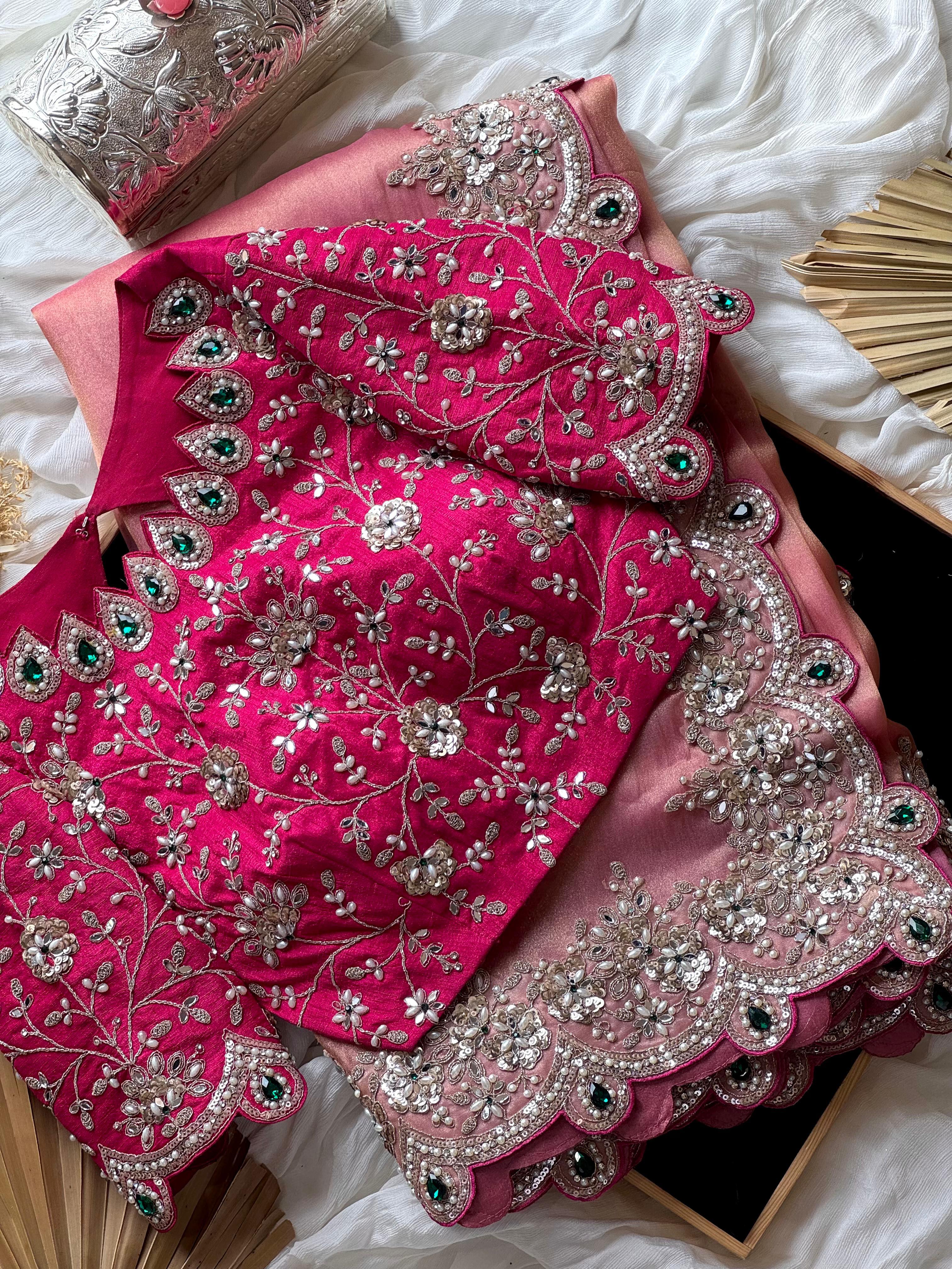 Onion Pink embroidered fabric with intricate silver and green detailing on a white surface.