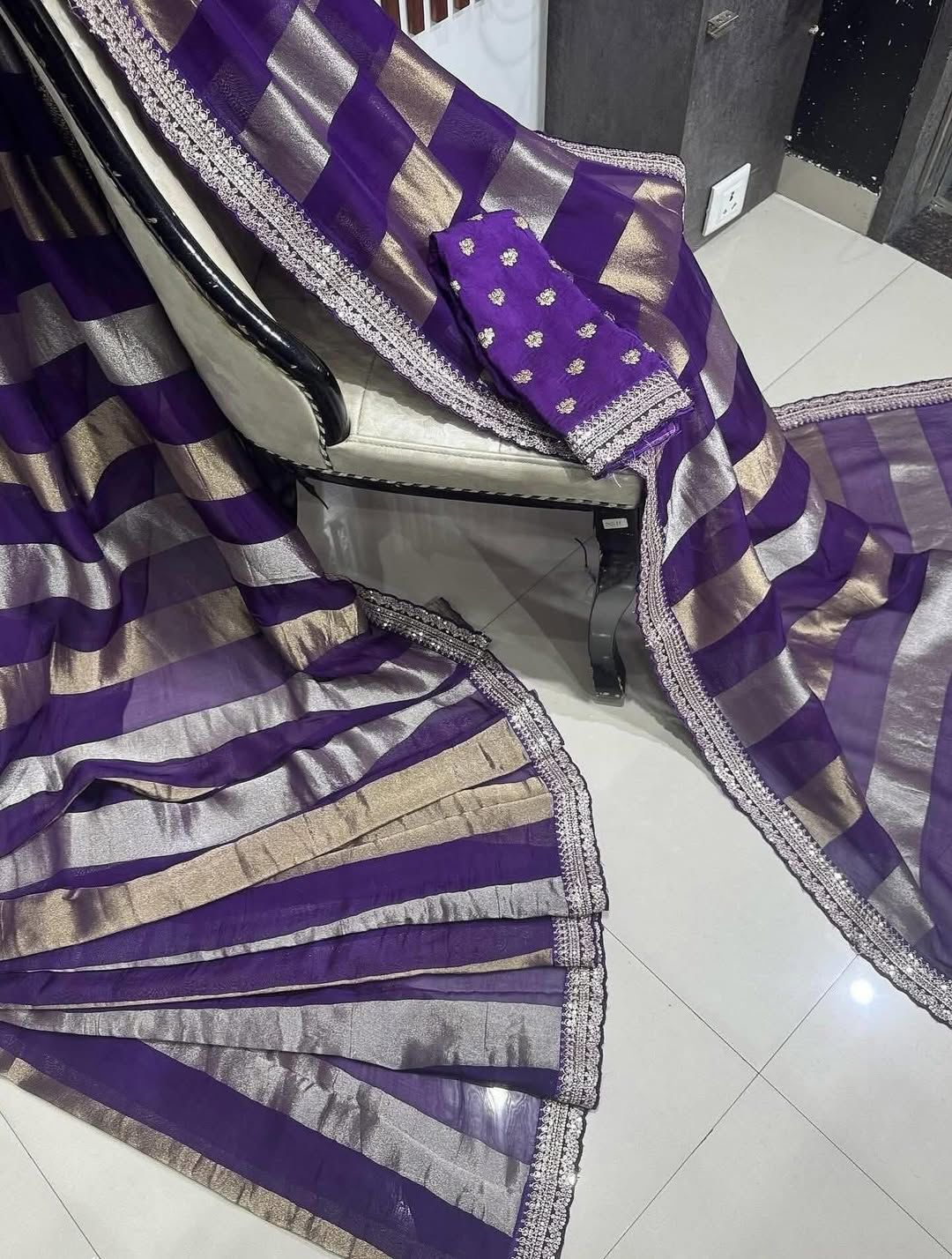 Purple and saree drape over a chair on a tiled floor.