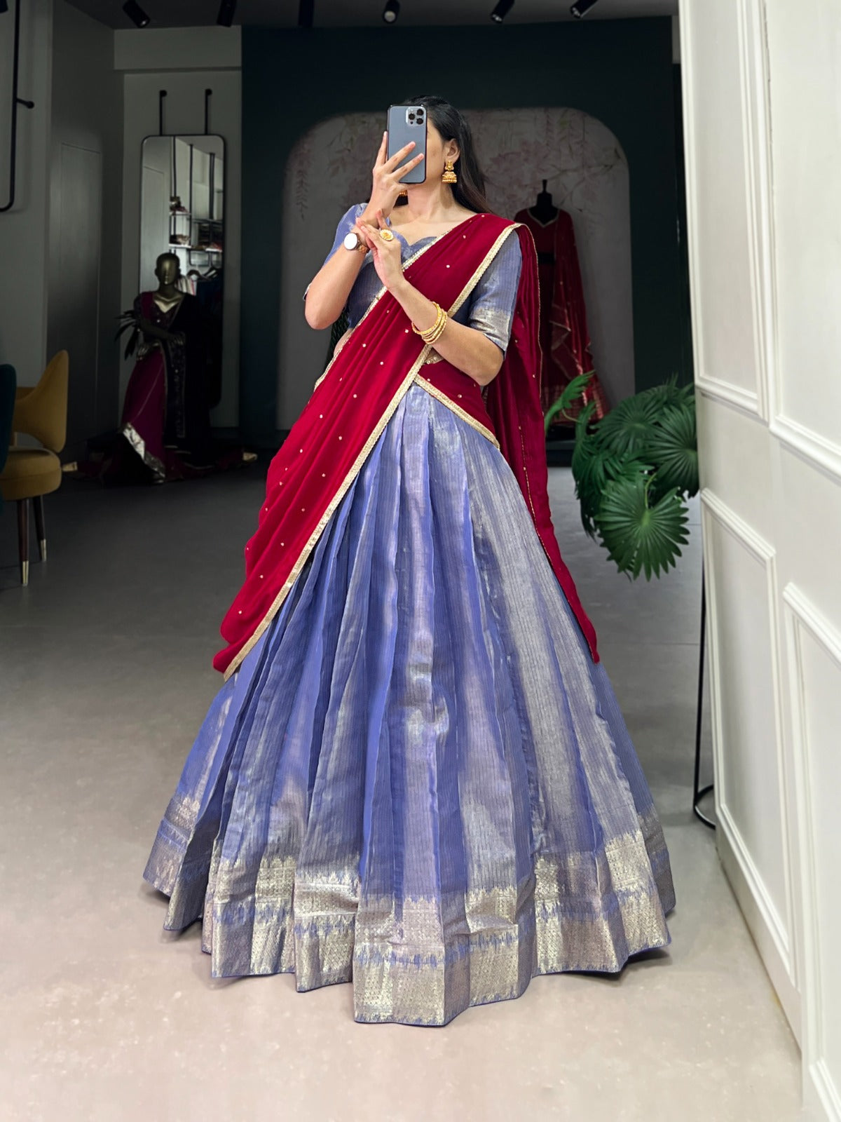 Lavender saree with a blouse in a room.